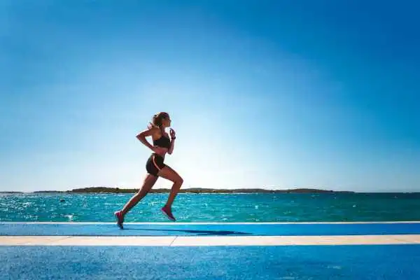 Woman running showing strong leg muscle Crewe